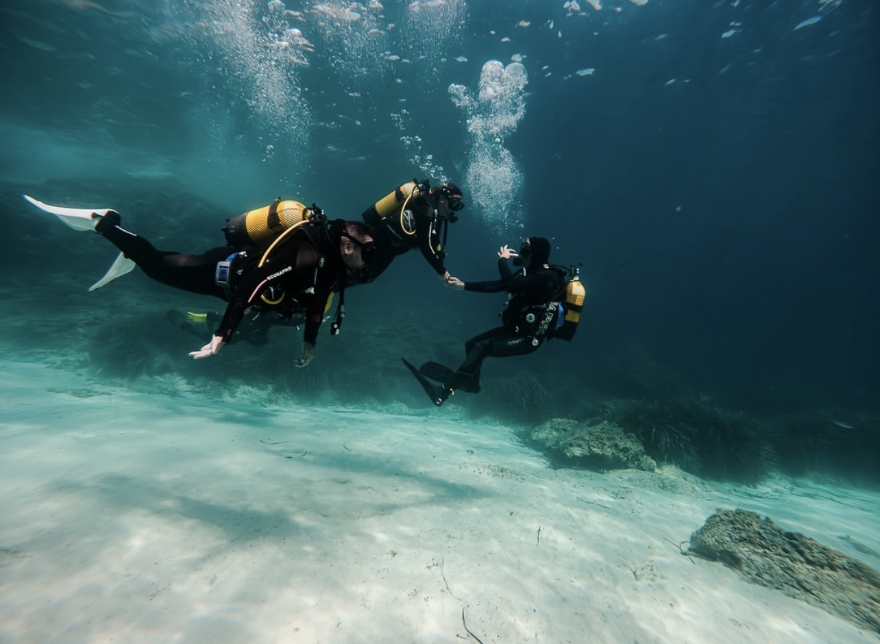 PADI instructor guiding students underwater during a training dive